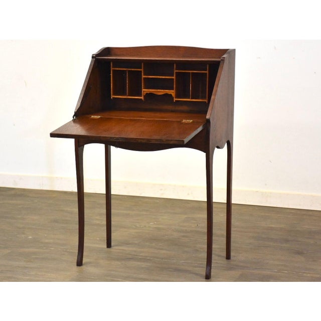 An early 1900’s mission style oak secretary desk with a drop front desk top. Would benefit from a new hinge but current...