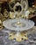 This luxury brass and crystal pedestal serving stand is designed to elevate elegant gatherings and refined table...