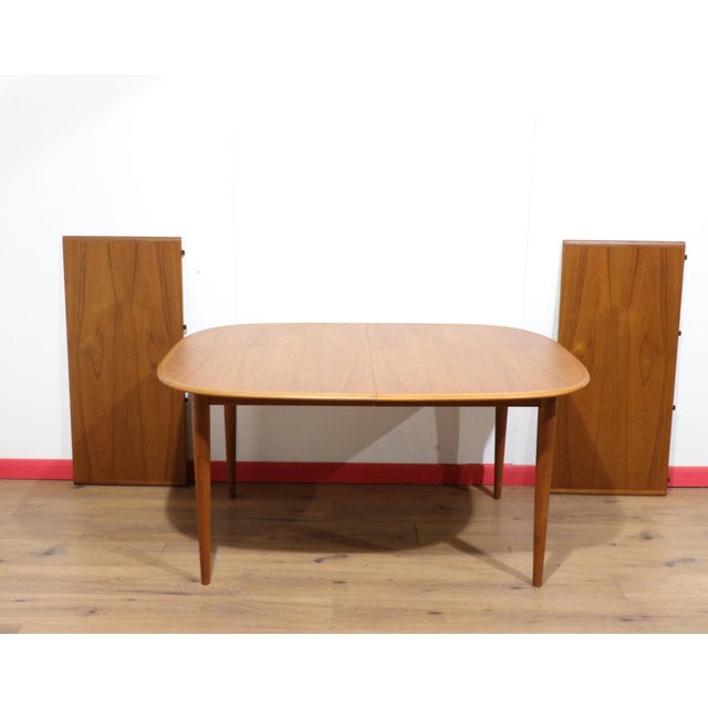 A truly stunning extending dining table with leaves, this Mid Century Modern Skovmand and Anderson Teak Danish piece...