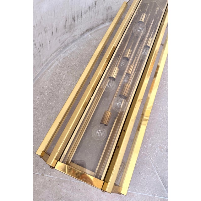 Mid-Century Modern Tall & Narrow Statement Pendant Chandelier in Brass With Clear Glass, in the Style of Robert Sonneman....