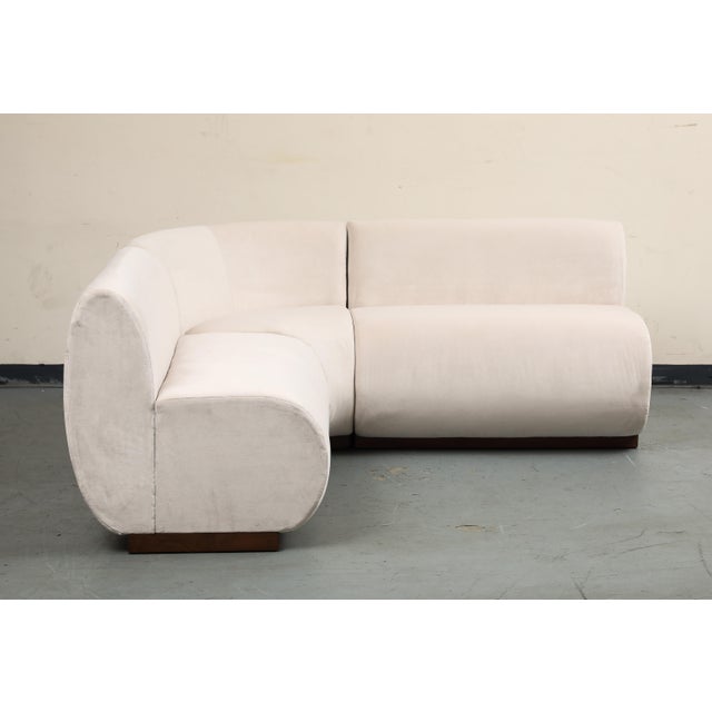 Contemporary 3-piece L-shaped dining banquette with a rounded corner, custom upholstered in ivory performance velvet...