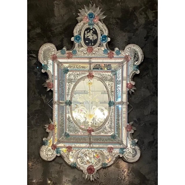 This beautiful Venetian mirror features etched floral motifs adorning the mirrored frame. Along the edges of the frame are...