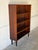 This open bookcase features a streamlined silhouette with four spacious shelves. It stands on tapered black legs that...