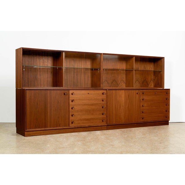 This unique and versatile matching pair of vintage Swedish mid-century modern display cabinets was produced circa 1960....