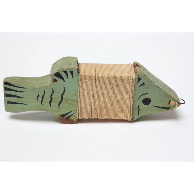 Hand carved and painted mint green fish souvenir spool from Nantucket Island (ca. 1940s, MA, USA). The fishing twine is...