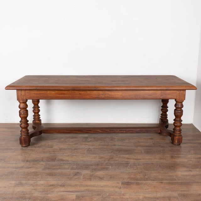 At just over 7' long, this substantial library table will make a great gathering place in today's modern home. The oak top...