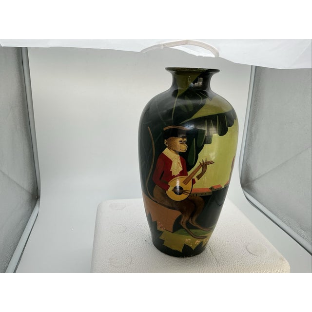 A wonderfully whimsical and highly decorative circa 1940 hand-painted ceramic vase featuring an enchanting scene of monkey...