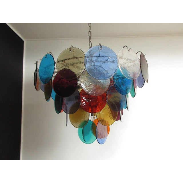 Italian murano chandelier. The chandelier has 50 murano multicolored glass disks. The glasses are now unavailable, they...