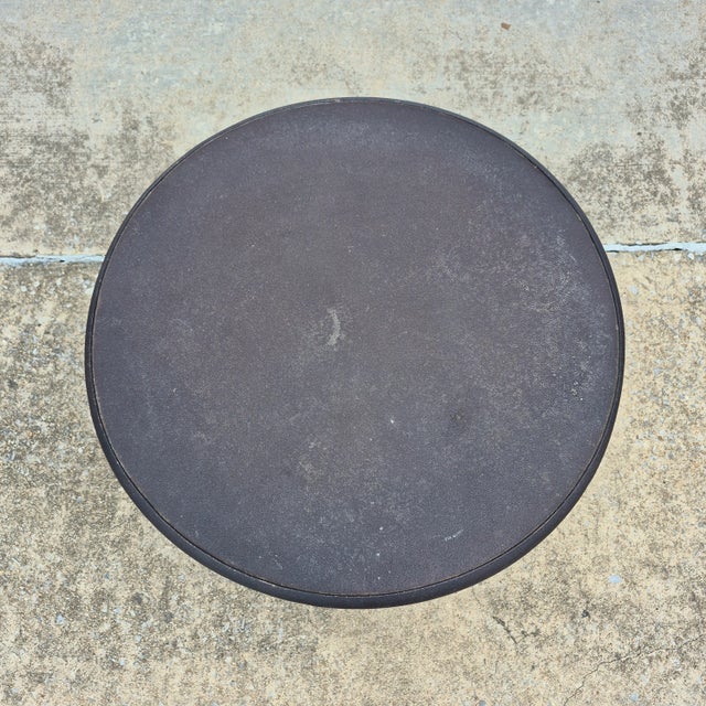 This is a round cast iron side table from Restoration Hardware, made in 2012, designed to evoke the neoclassical cafe...