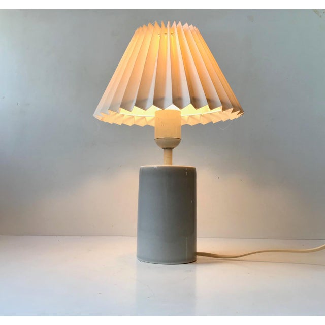 Cylindrical ceramic table light with applied celadon glaze. Designed by Aksel Larsen in Denmark during the 1970s and...