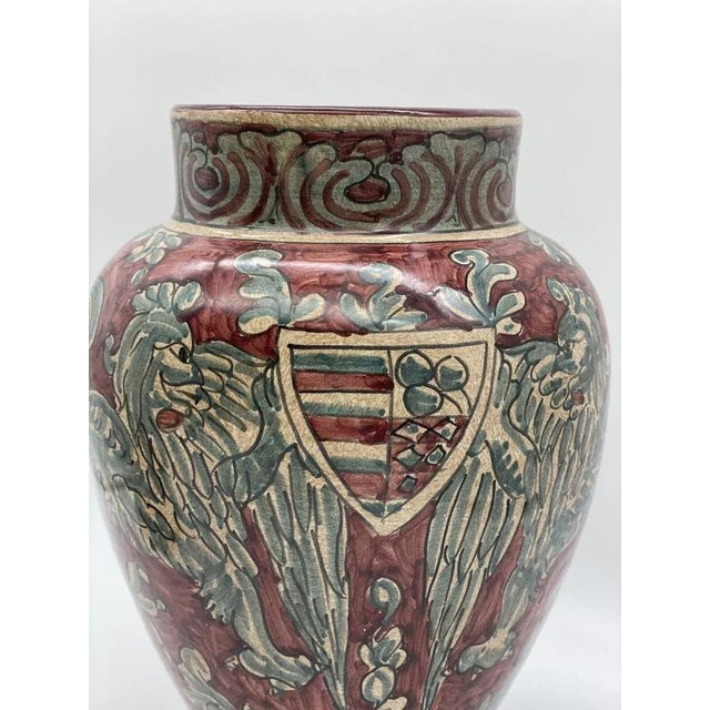 Baroque decoration to mythological subjects, dragons and griffins painted on the characteristic ruby ​​red background....