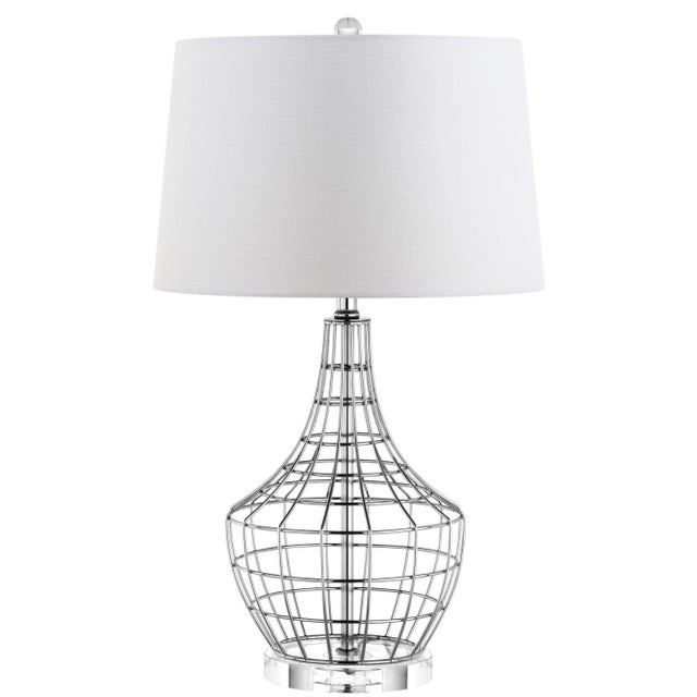 This contemporary table lamp adds modern industrial glamour to the living room. it's graphic metal cage design is finished...