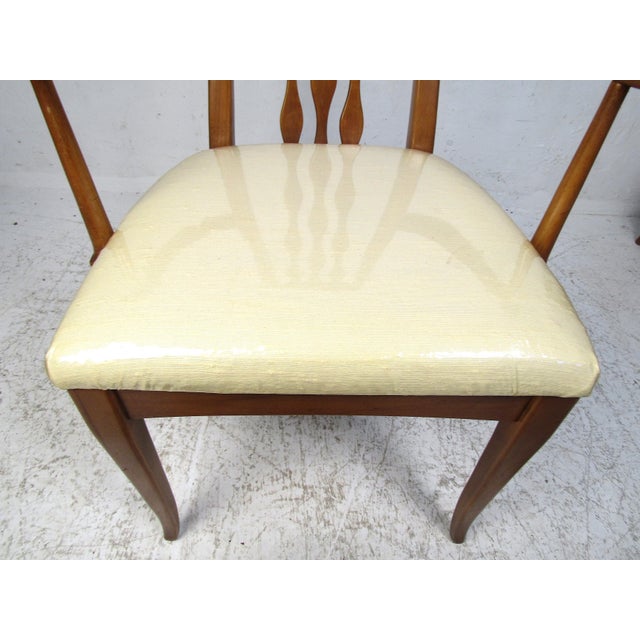 Unusual set of midcentury dining chairs manufactured by the American Furniture Company of Martinsville, Virginia. This set...