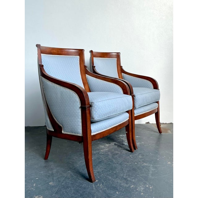 Imbue your living space or library with the refined elegance of this pair of vintage Neoclassical armchairs. Channeling...