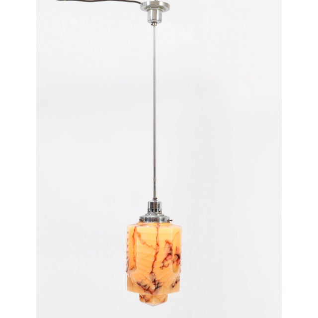 Magnificent Art Deco pendant light. Striking French design from the 1930s. Nickel-plated brass frame with original marble...