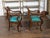 A pair of English Regency period mahogany armchairs from the mid 19th century, with ionic capitals, griffon arms and paw...