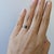 A green tourmaline takes centre stage in a fresh green at the heart of this solid 14K white gold ring, framed by six...