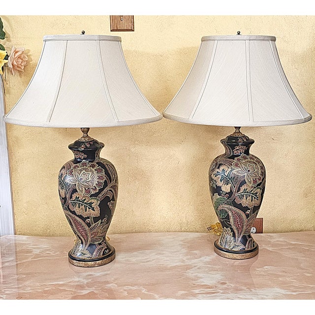 Elegant pair of Bradburn Gallery ceramic table lamps featuring hand-painted floral and botanical artwork on a black vase-...