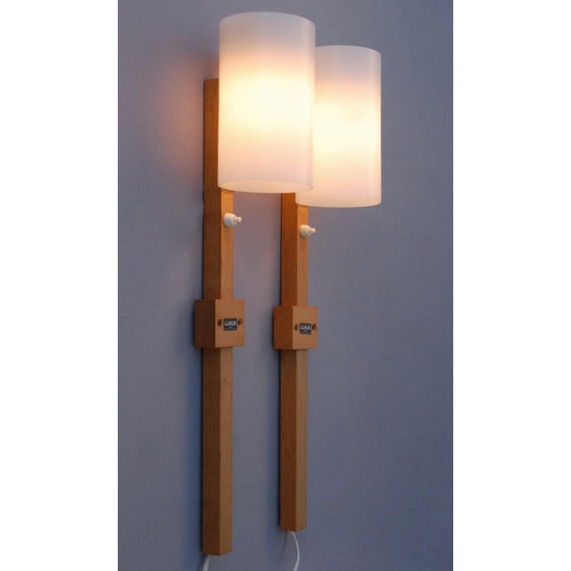 An exceptionally rare pair of wall lamps designed by uno & östen kristiansson for luxus vittsjö, sweden, during the 1960s....