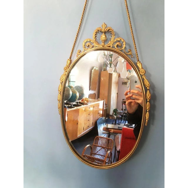 Vintage Oval Brass Mirror with Ornamental Decor, in Flawless conditions. Designed 1920 to 1949