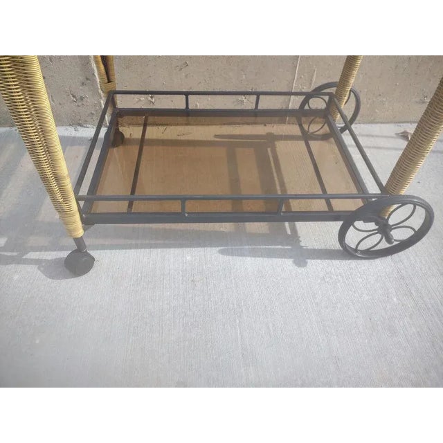 This large bar cart is perfect for serving drinks at your next gathering. Made with a combination of rattan and metal...