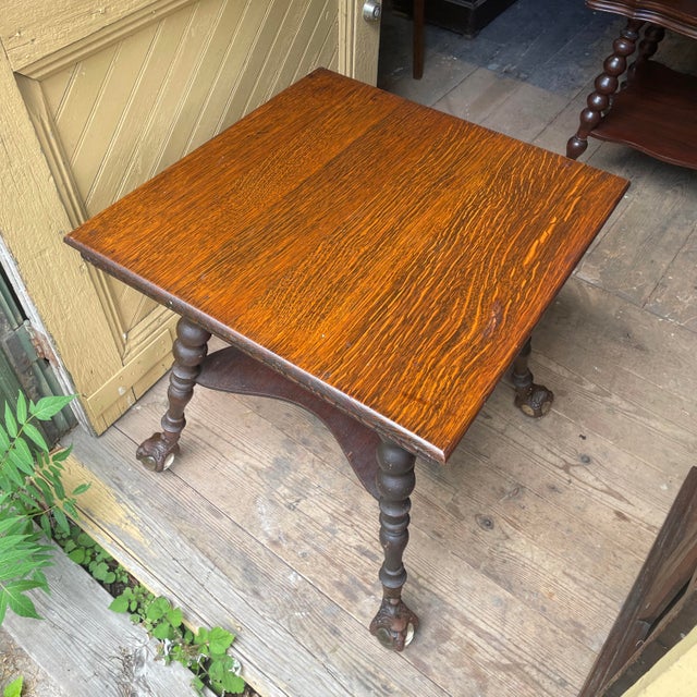 Gorgeous arts and crafts era oak side table with FIST-sized metal and glass ball-and-claw (and face!) feet. Wear and tear...