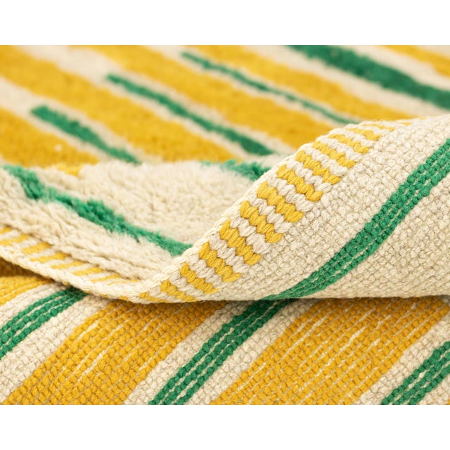 A rhythmic march of stripes, warm and grounded. This hand-knotted wool rug builds its impact through repetition — fine...