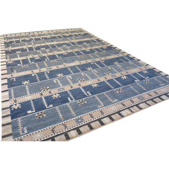 This beautiful handwoven Swedish-style rug features a fascinating combination of geometric stripes and figures paired with...