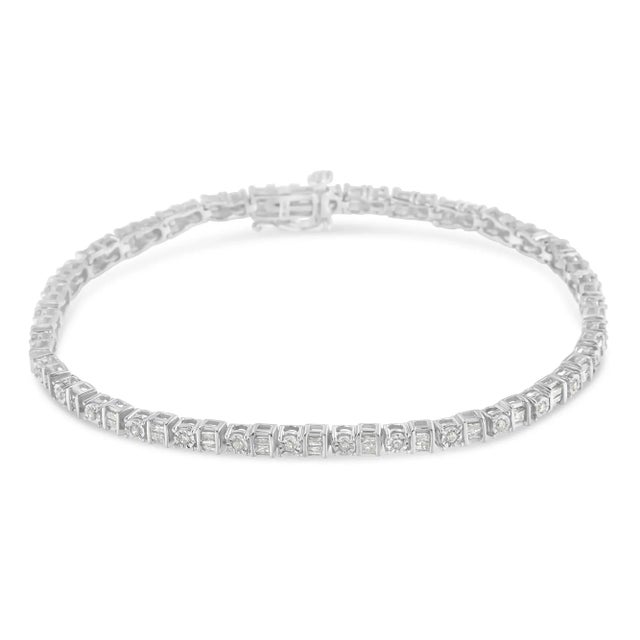 Elegant and timeless, this gorgeous sterling silver alternating station tennis bracelet features 1.0 carat total weight of...
