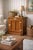 Solid oak icebox-style nightstand with raised panel door, polished brass hinges and latch, and original White Cap plaque —...