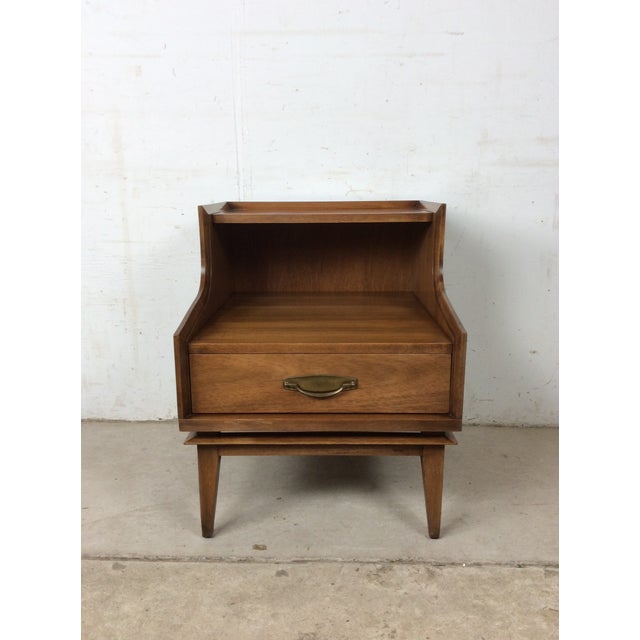This mid century modern nightstand by Kent Coffey features hardwood construction, original walnut finish, unique step...