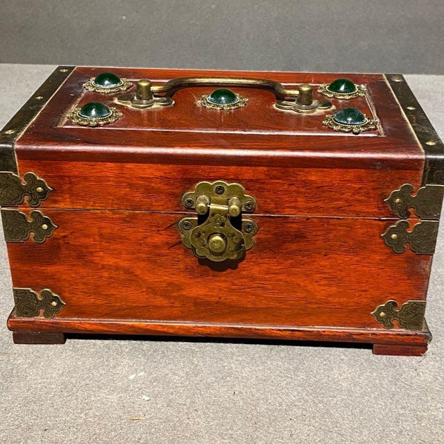 This beautifully crafted rectangular box features a stunning wood grain (appears to be rosewood or a similar dark...
