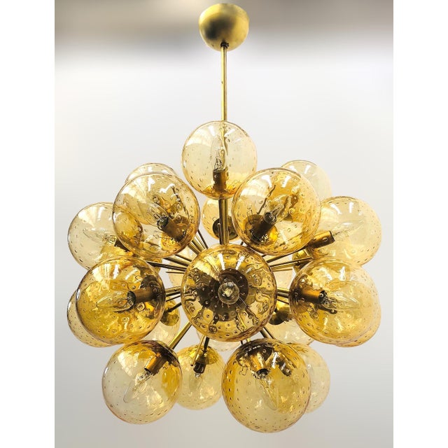Italian sputnik chandelier with 24 amber Murano glass globes carefully hand blown with bubbles inside the glass using...