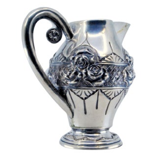 Wine Jug in Embossed Silver with Floral Motifs and Resting on Frilled Base For Sale