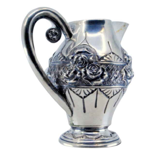 Wine Jug in Embossed Silver with Floral Motifs and Resting on Frilled Base For Sale