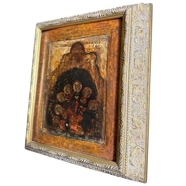 A painted Russian icon presented in a deep carved giltwood frame. The icon depicts the 7 Holy Youths, or “Seven Sleepers”...