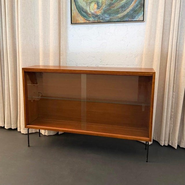 This streamlined Scandinavian modern bookcase display cabinet is a versatile storage choice for any design layout. The...