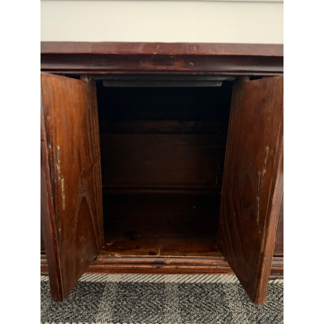 A striking Chinese hardwood bench or low sit-on piece, believed to be antique or early vintage and designed in the...