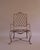 Rose Tarlow style "Twig" outdoor set of (4) chairs and (1) Ottoman. Wrought iron metal frames in forms of twisting vines...