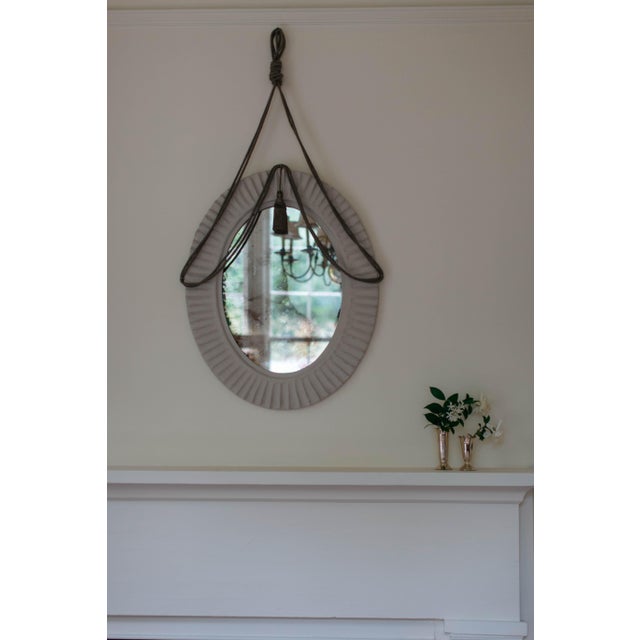 The Merette Mirror has the presence of a piece collected over time. Sculptural yet delicate, it pairs a fluted papier...