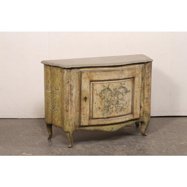 An Italian hand-painted, and shapely, wooden console cabinet from the 19th century. This antique credenza from Italy has a...