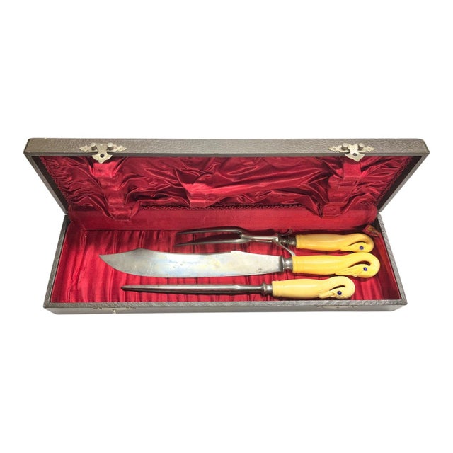 Fantasmagorical set of three serving utensils in satin lined box. 19th century carved handles depicting swans with inlaid...