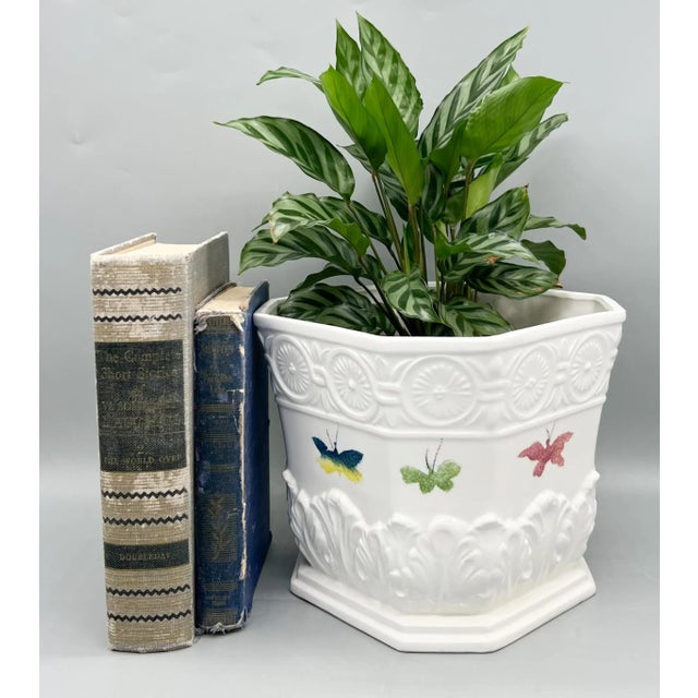Charming vintage Italian ceramic cachepot featuring embossed neoclassical detailing and hand-painted butterflies in soft...
