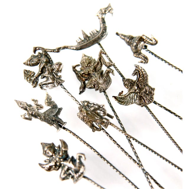 Fabulous set of 8 vintage c.1950's sterling silver cocktail picks with various Thai and Buddhist forms on them, all...