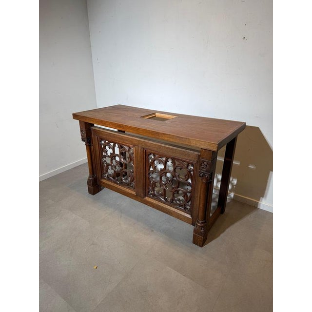 Impressive carved wooden altar or architectural console executed in a Gothic style, featuring richly sculpted tracery...
