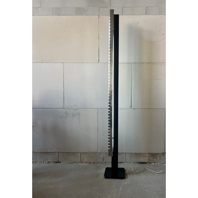 Sculptural Italian Modernism in Light and Steel A striking floor lamp by Lamperti, Italy, dating from the 1970s. Defined...