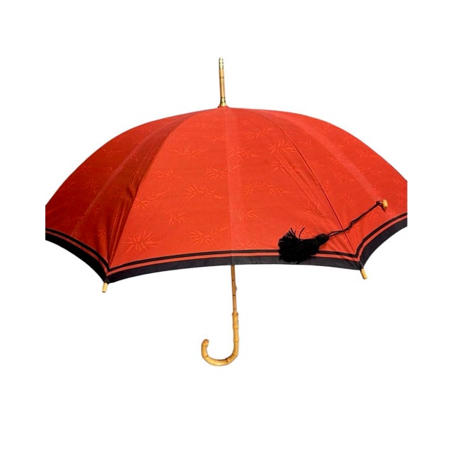 A lovely, vintage YSL tassel umbrella. Features a tone-on-tone red floral pattern accented with navy trim and adorned with...