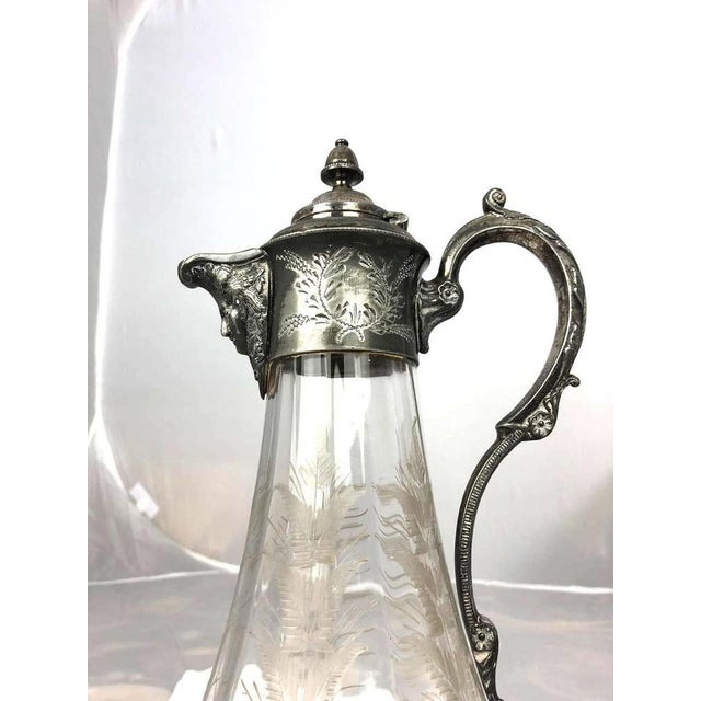 A stunning 19th century art nouveau claret jug which has the function for holding red wine and water. The jug has silver...