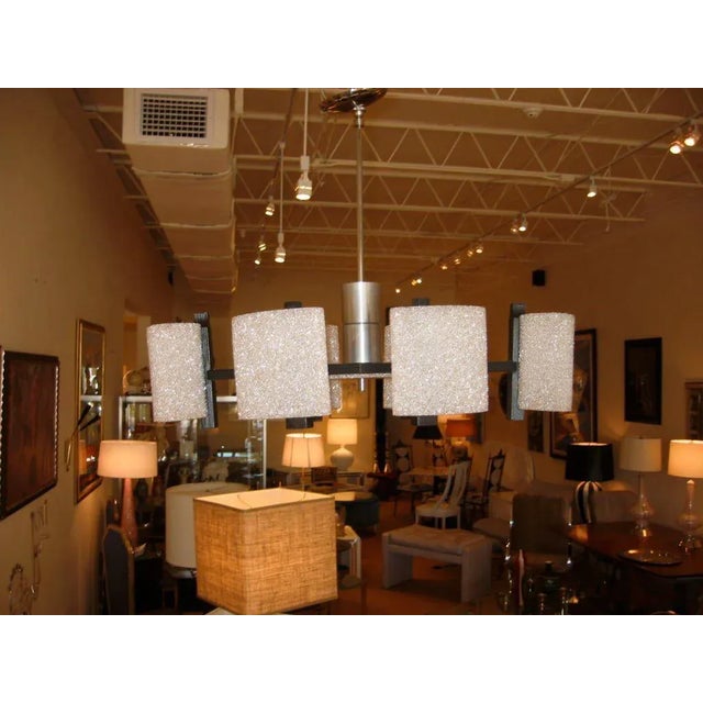 This vintage 1950s mid-century modern chandelier is comprised of crushed acrylic formed into oval shaped shades resembling...