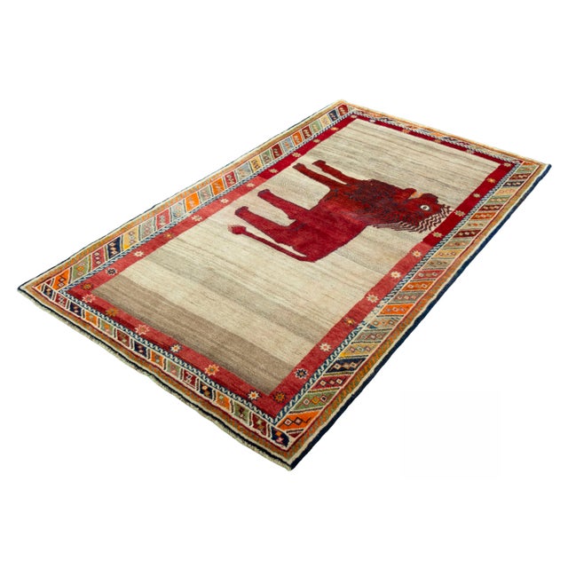 A truly unique piece from the world of nomad art: This hand-knotted Gabbeh rug impresses with its charismatic lion motif,...